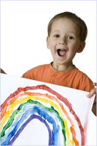 Picture of boy holding painting of a rainbow